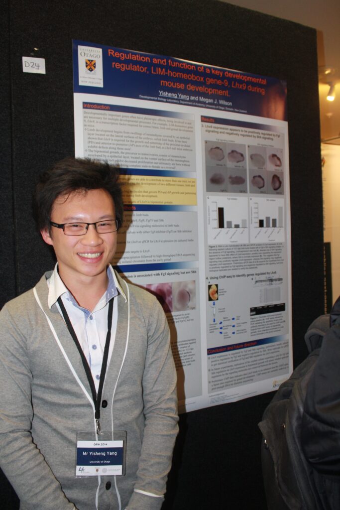 Photo of Yisheng Yang standing infront of his research poster.