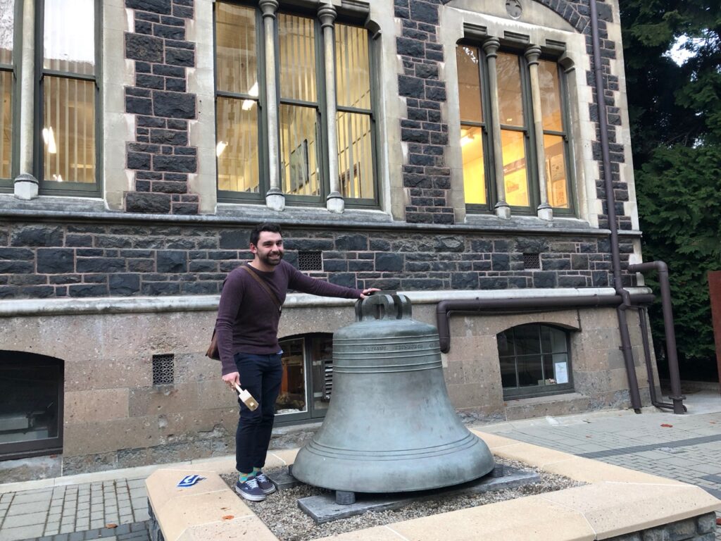Photo of researchers hitting the university bell