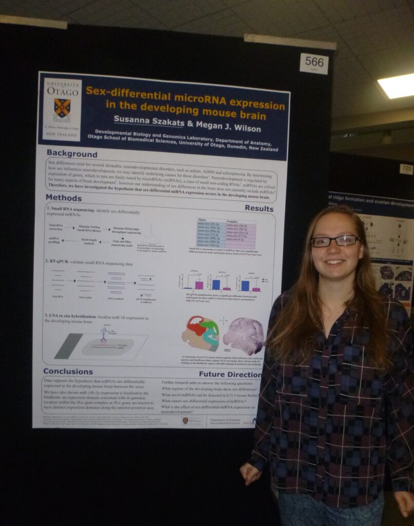 Photo of Susie Szakats standing infront of her research poster