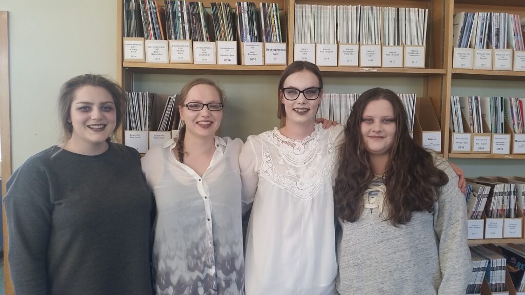 Photo of postgrad girls from the labratory with ghost makeup.